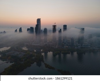 Aerial view of highrise condo and business office buildings, constructions by the lake halfway covered with fog, mist, haze and low clouds. Rapidly changing weather, poor visibility.Humber Bay Park. - Powered by Shutterstock