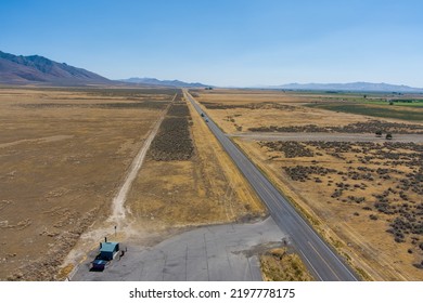 Aerial View Of Highway 95 Located In The Northern Nevada Desert With A Hazy Blue Sky And Copy Space.