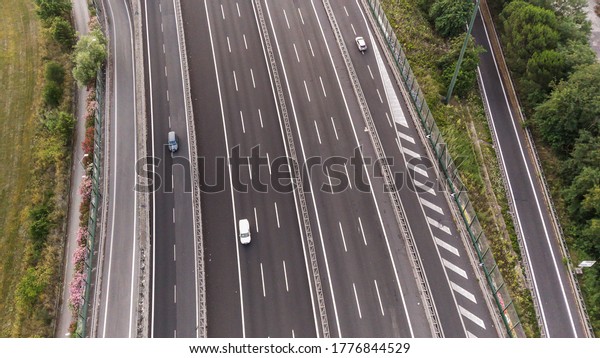 Aerial view of highway in city. Cars crossing\
interchange overpass. Highway interchange with traffic. Aerial\
bird\'s eye photo of highway. Expressway. Road junctions. Car\
passing. Top view from\
above.