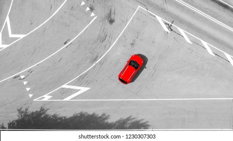 Aerial view of highway. Aerial view of a country road with moving red car. Car passing by. Aerial road. Aerial view flying. Captured from above with a drone. Black and white