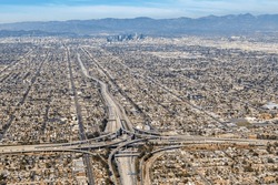 Aerial View Of Highway Interchange Harbor And Century Freeway Traffic With Downtown City Los Angeles, USA
