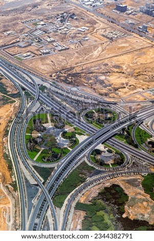 Aerial view of highway interchange. Road junction. Residential buildings, squares and streets in Oman