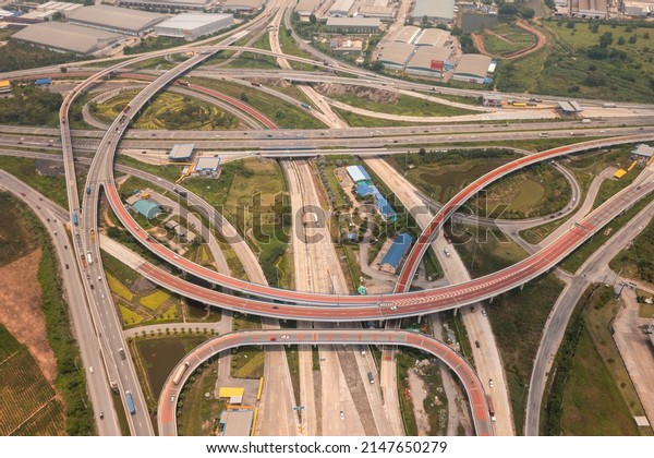 Aerial view\
of highway junctions with roundabout. Bridge roads shape circle in\
structure of architecture and transportation concept. Top view.\
Urban city, Bangkok at sunset,\
Thailand