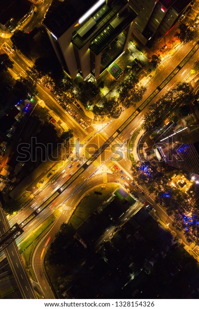 Aerial view of highway junctions shape letter x\
cross at night. Bridges, roads, or streets in transportation\
concept. Structure shapes of architecture in urban city, Kuala\
Lumpur Downtown,\
Malaysia