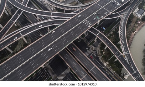Aerial view of highway and overpass in city on a cloudy day - Shutterstock ID 1012974310