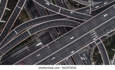 Aerial view of highway and overpass in city on a cloudy day - Shutterstock ID 1012974331