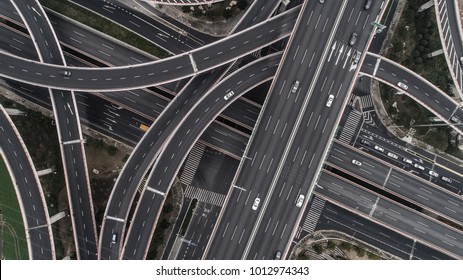 Aerial view of highway and overpass in city on a cloudy day - Shutterstock ID 1012974343