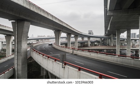 Aerial view of highway and overpass in city on a cloudy day - Shutterstock ID 1015966303
