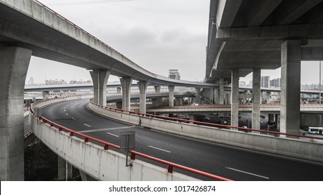 Aerial view of highway and overpass in city on a cloudy day - Shutterstock ID 1017426874