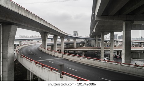 Aerial view of highway and overpass in city on a cloudy day - Shutterstock ID 1017426886