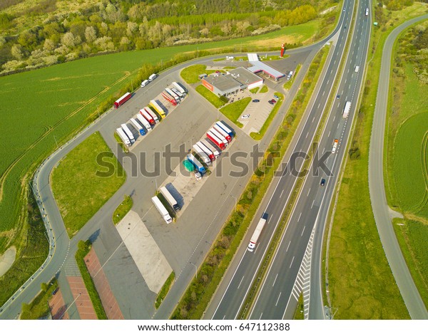 Aerial view of highway rest area with\
restaurant and large car park for cars and trucks. D5 motorway in\
west Bohemia, Czech republic, European union. Top view of highway\
infrastructure.