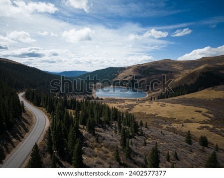 An aerial view of the highway road on a forested hillside in the Guanella Pass