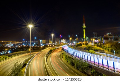 Aerial View Of Highways, Urban Light Trail (Bike Path/ Pedestrian Walkway), And Auckland Skyline At Night - Auckland, New Zealand 