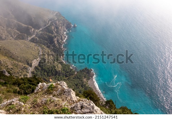 Aerial view from a hiking trail on the coastal\
driving road of the beautiful scenic Amalfi Coast, Campania, Italy,\
Europe. Riviera coastline at Mediterranean sea. Panoramic curvy\
road near Positano
