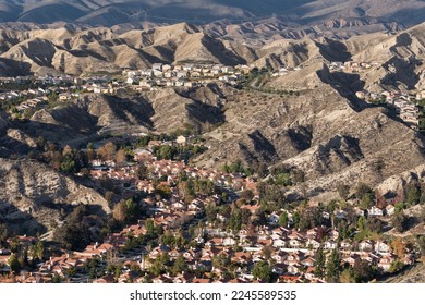 Aerial view of hillside housing tracts in suburban Santa Clarita near Los Angeles California.