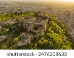 Aerial view of the historic Alhambra palace at sunset in Granada, Andalusia, Spain. The ancient Arabic fortress Alhambra during the beautiful evening. Aerial drone footage of Granada cityscape