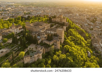 Aerial view of the historic Alhambra palace at sunset in Granada, Andalusia, Spain. The ancient Arabic fortress Alhambra during the beautiful evening. Aerial drone footage of Granada cityscape - Powered by Shutterstock