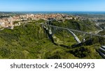 Aerial view of the historic center of Catanzaro and the famous access bridge to the city. It is the capital of Calabria, southern Italy. In the background is the Ionian Sea.