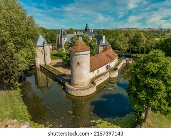 Aerial view of historic monument Bannegon castle in France on the border between Berry and Bourbonnais, with imposing keep, drawbridge, and a trapezoidal fortified enclosure, water filled moat