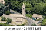 Aerial view of the historic san rocco di camogli church and its bell tower amidst a verdant landscape in liguria, italy