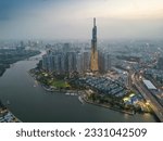 Aerial view of a Ho Chi Minh City, Vietnam with development buildings, transportation, energy power infrastructure. Financial and business centers. Sunset to night. Travel and landscape concept.