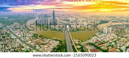 Aerial view of Ho Chi Minh City skyline and skyscrapers in center of heart business at Ho Chi Minh City downtown. Cityscape on Saigon river in Ho Chi Minh City, Vietnam at sunset scene