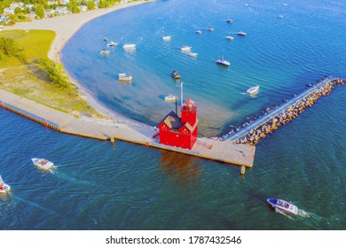 Aerial view of the Holland Harbor Lighthouse, known as the Big Red Lighthouse, at the channel connecting Lake Macatawa with Lake Michigan; Holland State Park, Michigan  - Powered by Shutterstock