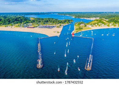 Aerial view of the Holland Harbor Lighthouse, known as the Big Red Lighthouse, at the channel connecting Lake Macatawa with Lake Michigan; Holland State Park, Michigan  - Powered by Shutterstock