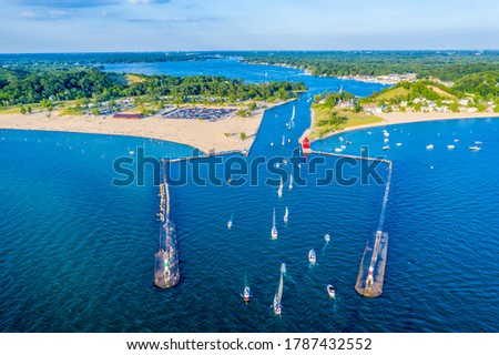 Aerial view of the Holland Harbor Lighthouse, known as the Big Red Lighthouse, at the channel connecting Lake Macatawa with Lake Michigan; Holland State Park, Michigan 