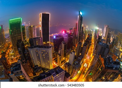Aerial view of Hong Kong skyscrapers at night from Wooloomooloo Bar, located on rooftop of The Hennessy in Wan Chai, Hong Kong island. Fisheye view.