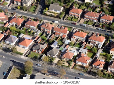 Aerial View Of Houses On A  Housing Estate In The UK. One House Has Solar Panels On A Garage Roof.