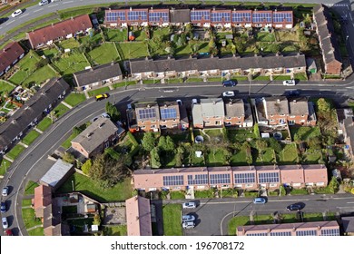 Aerial View Of Houses On A UK Housing Estate, Some With Solar Roof Panels