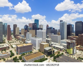 Aerial view Houston downtown against cloud blue sky with empty parking lot at weekends, building/high-rises under construction and background of skyscrapers in the business district area - Shutterstock ID 682282918