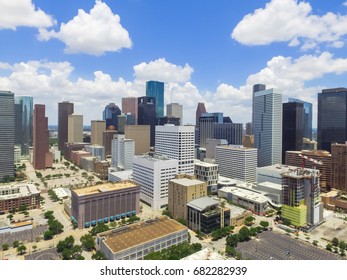 Aerial view Houston downtown against cloud blue sky with empty parking lot at weekends, building/high-rises under construction and background of skyscrapers in the business district area - Shutterstock ID 682282939