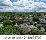 aerial view of hudson, new york (small hudson valley town city downtown historic district) mountains catskills ny travel destination main street with hills clouds cars tree matter