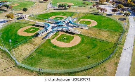 Aerial view huge baseballsoftball complex with natural grass fields, ticket offices, batting cages, pavilion, spectator seating Dallas, TX. Large sport facility venue for practice, tournaments