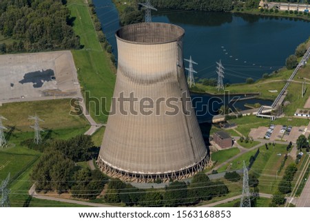 Aerial view of huge coolingtower from a coal and biomass fired powerplant at river Amer near Geertruidenberg, in The Netherlands.