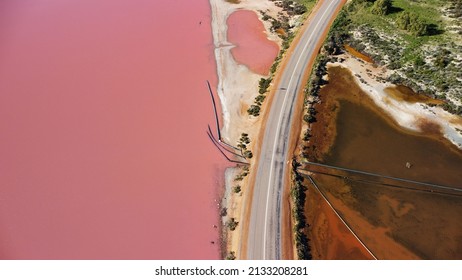 Aerial View Of Hutt Lagoon Pink Lake In Western Australia. Separated By Road, On One Side Boasts A Pink Hue Lake And On The Other Is A Regular Irrigation Dam.