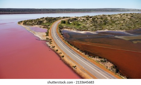 Aerial View Of Hutt Lagoon Pink Lake In Western Australia. Separated By Road, On One Side Boasts A Pink Hue Lake And On The Other Is A Regular Irrigation Dam