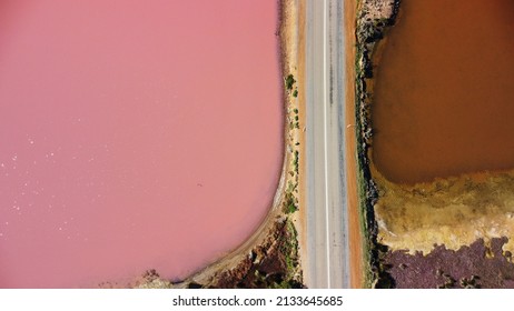 Aerial View Of Hutt Lagoon Pink Lake In Western Australia. Separated By Road, On One Side Boasts A Pink Hue Lake And On The Other Is A Regular Irrigation Dam