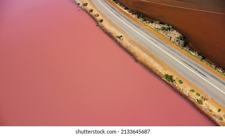 Aerial View Of Hutt Lagoon Pink Lake In Western Australia. Separated By Road, On One Side Boasts A Pink Hue Lake And On The Other Is A Regular Irrigation Dam