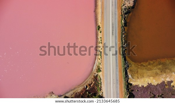 Aerial view of Hutt Lagoon Pink\
Lake in Western Australia. Separated by road, on one side boasts a\
pink hue lake and on the other is a regular irrigation\
dam