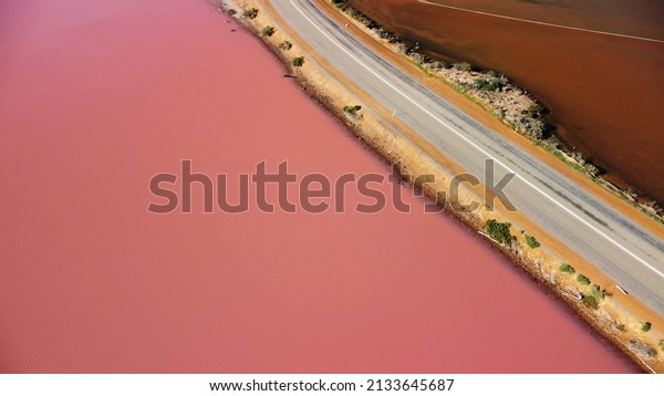 Aerial view of Hutt Lagoon Pink\
Lake in Western Australia. Separated by road, on one side boasts a\
pink hue lake and on the other is a regular irrigation\
dam