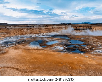 Aerial view of Hverir Geothermal Area in Iceland, capturing boiling mud pools, fumaroles, and the dramatic landscape of this geothermal hotspot near Lake Mývatn. - Powered by Shutterstock