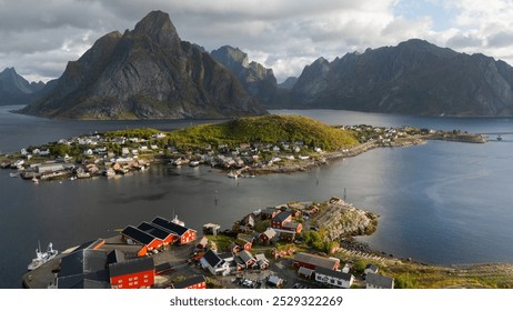 Aerial view of idyllic rainbows over Olstind mountain and fishermen cabins by the sea, Sakrisoy, Reine, Lofoten Islands, Nordland, Norway, Scandinavia, Europe - Powered by Shutterstock