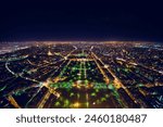 aerial view of illuminated night city panorama of Paris with street lights, drone top view from above, Champs Elysees and Elysee Palace, France