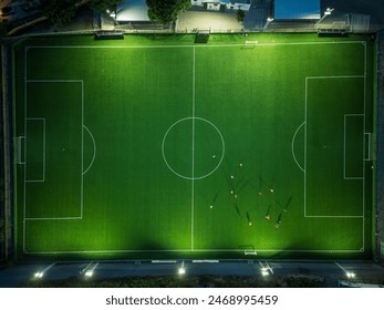 Aerial View of an Illuminated Soccer Field at Night - Powered by Shutterstock