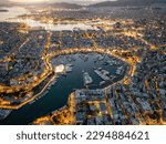 Aerial view of the illuminated Zea Marina in Piraeus, Athens, Greece, with lined up sailing boats and yachts during evening