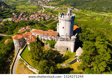 Aerial view of impressive medieval Branik Castle on hill above village of Branik in southwestern Slovenia