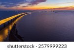 Aerial view of Incheon Bridge with traffic and travelers by the sea at Songdo-dong, Yeonsugi-gu, beautiful golden sky, Incheon, South Korea.